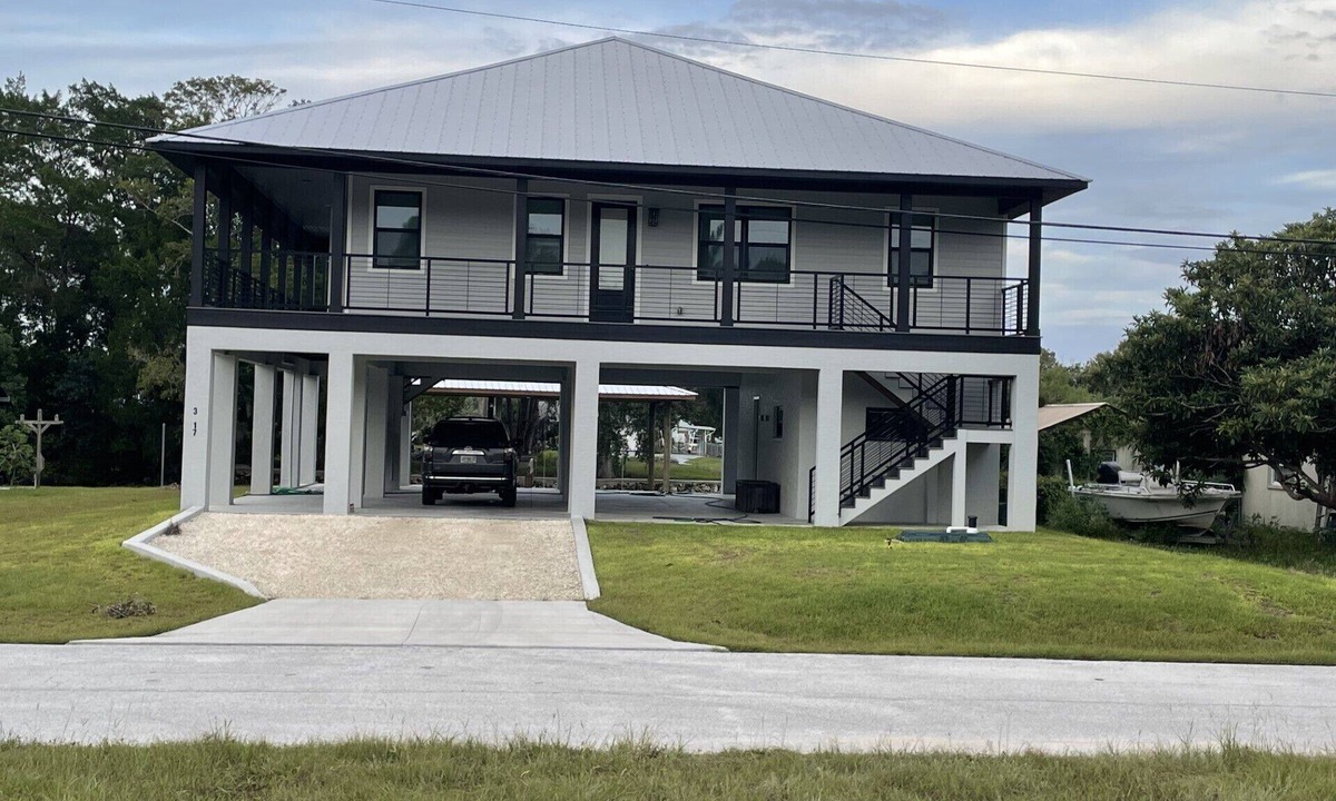 Indian Waters House | New Stilt Home on quiet canal with wrap around porch.
