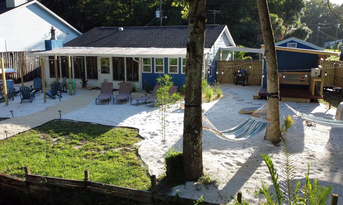 Weeki Wachee Gardens House | River Beach Retreat: with Tiki Bar, Fire Pit, Hot Tub & Clear Kayak