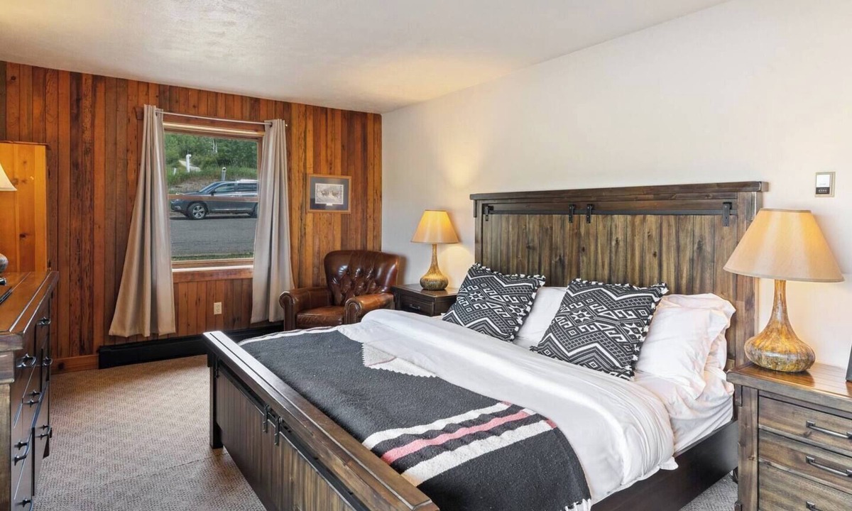 Clark Cabin | Spacious private king suite in the True North Adventure Lodge. Includes a king bed, private ensuite bathroom, and access to shared lodge amenities like the kitchen, great room, and hot tub. Ideal for couples or guests wanting extra space.
