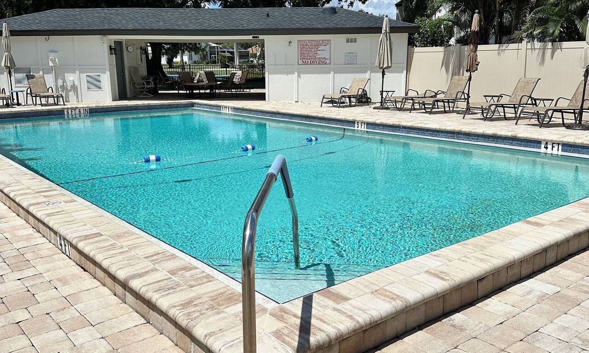 Biggar Condo | Vacation in the Forest CC heated pool view of golf course near beaches airport