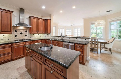 Jog Road House | Canal-Front Retreat Pool + Hot Tub + Dock Walk to Beach | Beach Drive Estate