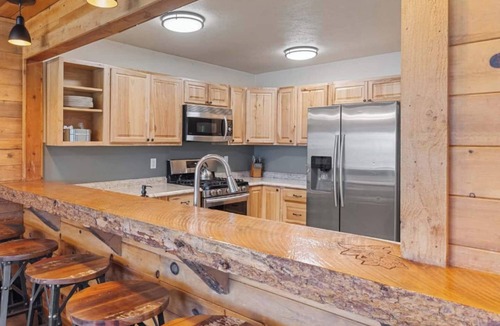 Clark Cabin | Comfortable private queen room in the True North Adventure Lodge. Includes a queen bed, private ensuite bathroom, and access to shared amenities like the kitchen, great room, and hot tub. Great for couples or solo travelers.