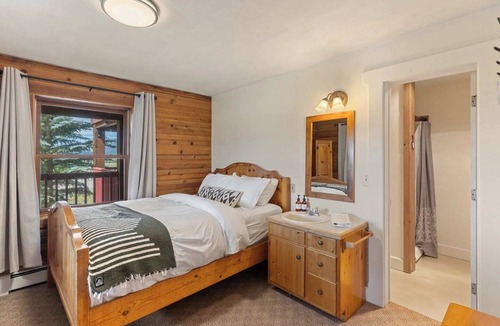 Clark Cabin | Comfortable private queen room in the True North Adventure Lodge. Includes a queen bed, private ensuite bathroom, and access to shared amenities like the kitchen, great room, and hot tub. Great for couples or solo travelers.