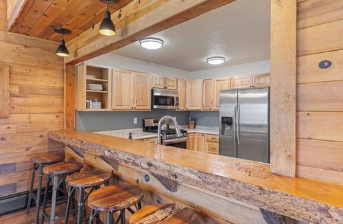 Clark Cabin | Comfortable private queen room in the True North Adventure Lodge. Includes a queen bed, private ensuite bathroom, and access to shared amenities like the kitchen, great room, and hot tub. Great for couples or solo travelers.