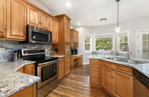 Windsor House | Cozy 4-bedroom home featuring a fun game room, private basement media room, a warm fireplace, and a spacious backyard deck perfect for relaxing and gathering together.