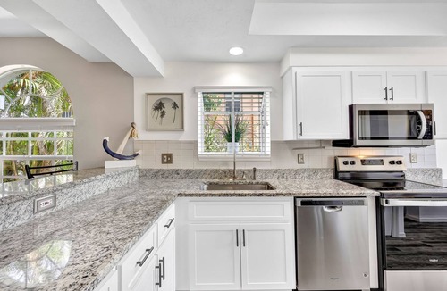 Caloosahatchee Villa | Enchanting tropical waterfront villa with boat slip, bikes, kayaks heated pool!