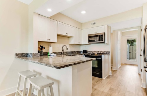 Upper Grand Lagoon Condo | Golf course-adjacent home with shuffleboard table & furnished patio