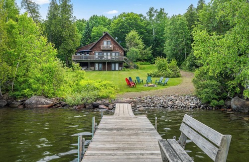 Rangeley Plantation House | Stone - This Rangeley Lake home has a very level entry to the water with a huge deck!