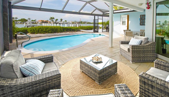CAPRI PARADISE! Beautiful waterfront home. Solar heated pool, 130ft dock.