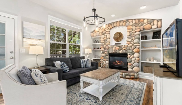 Cozy 4-bedroom home featuring a fun game room, private basement media room, a warm fireplace, and a spacious backyard deck perfect for relaxing and gathering together.