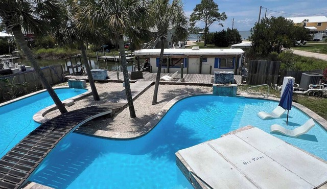 Hidden Hideaway on St. George Island canal w/saltwater pool, spa, dock, kayaks
