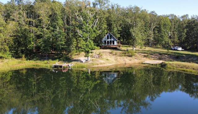 Peaceful secluded cabin nestled on 40 wooded acres overlooking 4 acre pond. in Cabool